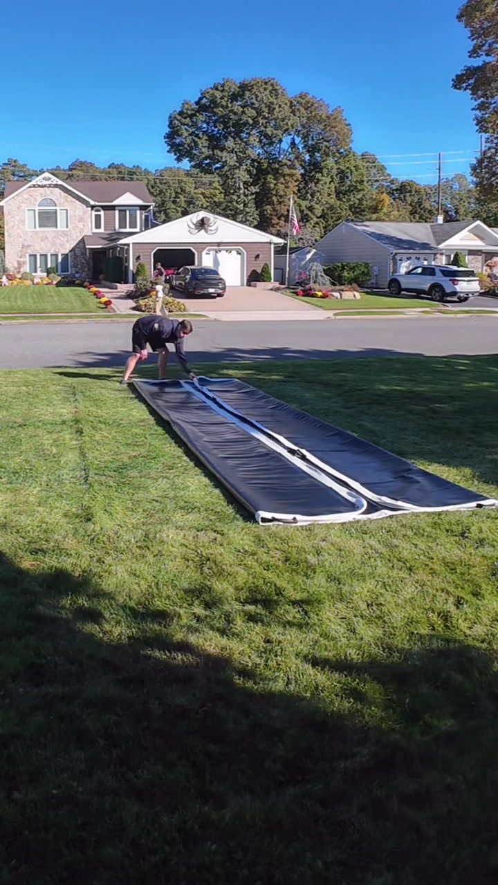 Folding both long sides of the deflated mat in to the middle, making a long narrow strip