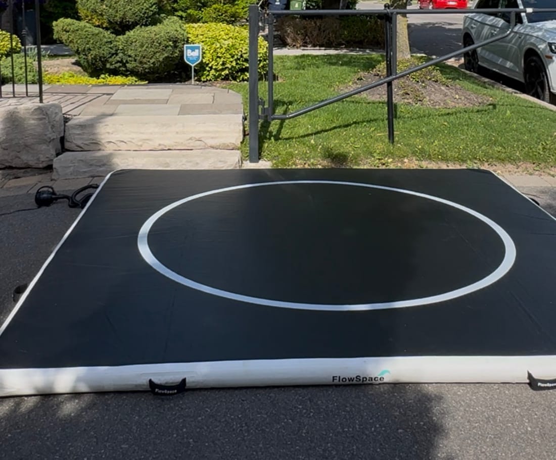 A 10 by 10 FlowMat inflated on a driveway in front of a house
